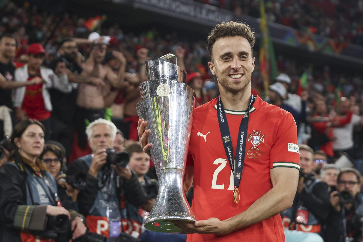 Diogo Jota holds up a trophy