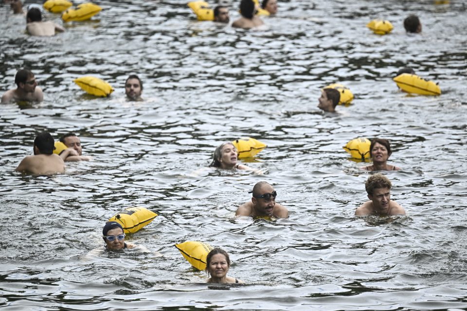 People swim at the Pont Marie safe bathing site on the Seine.