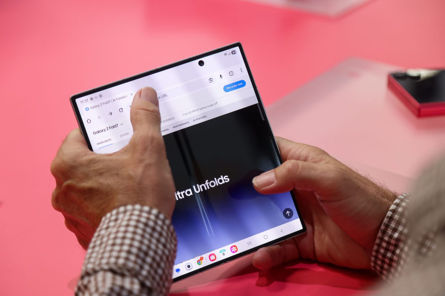 A man holds a foldable Samsung phone