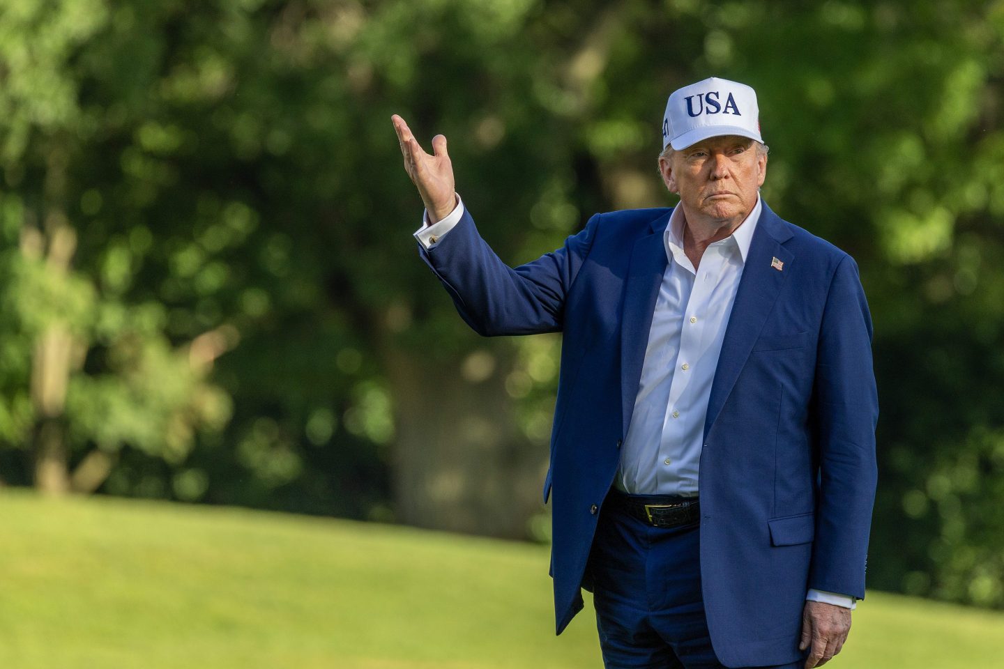 U.S. President Donald Trump looks up at the new flag on the south lawn of the White House on July 06, 2025.