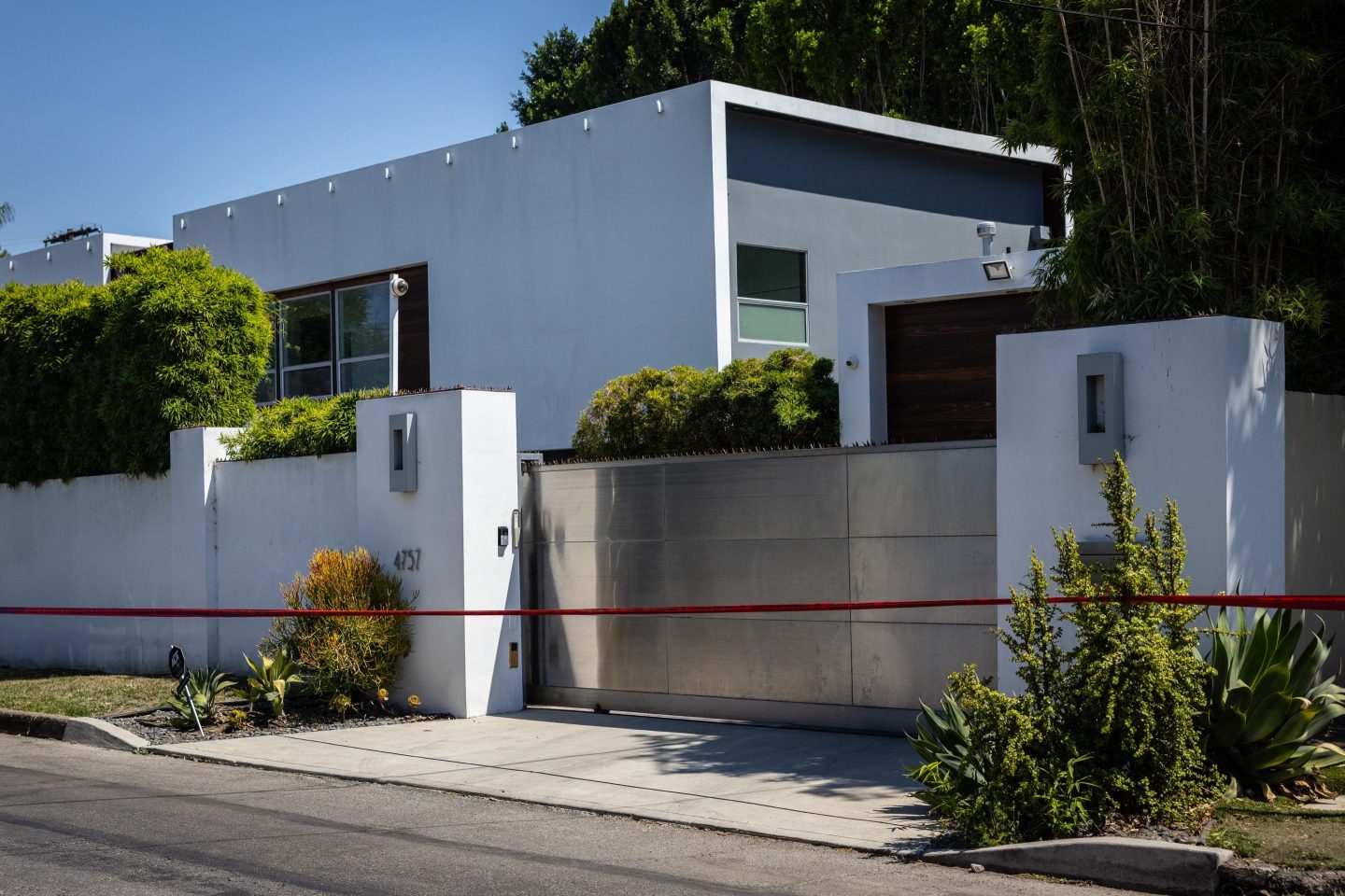 Los Angeles Police Department officials secure the home where Robin Kaye an "American Idol" music supervisor and her husband Thomas Deluca were found killed with gunshot wounds to the head