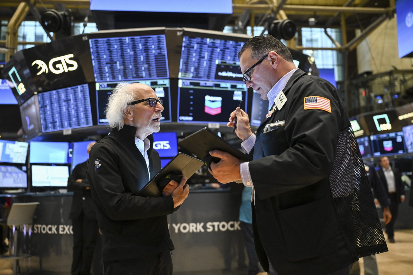 Traders work on the floor of the New York Stock Exchange at the opening bell on Friday.