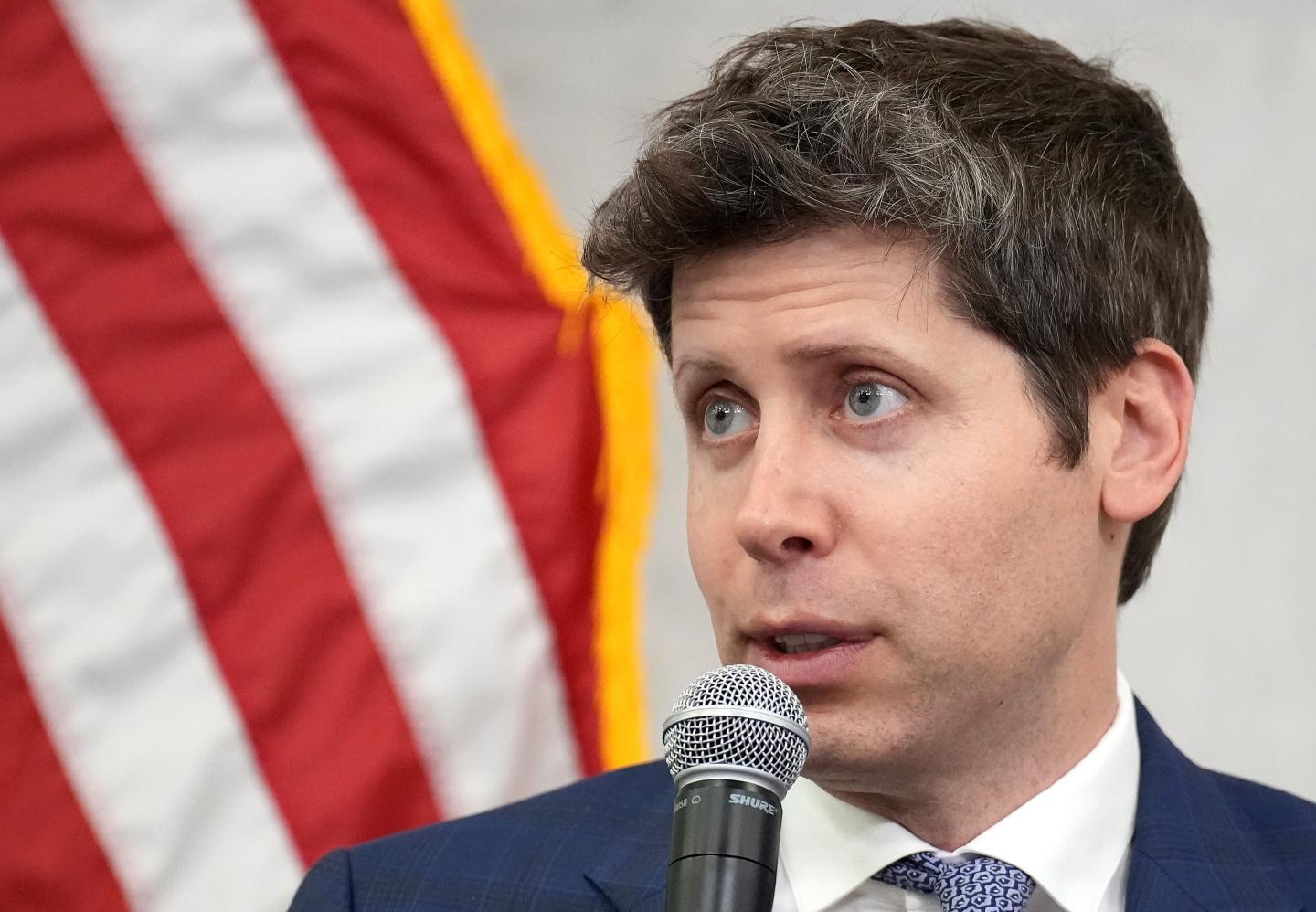 Sam Altman in front of the American flag