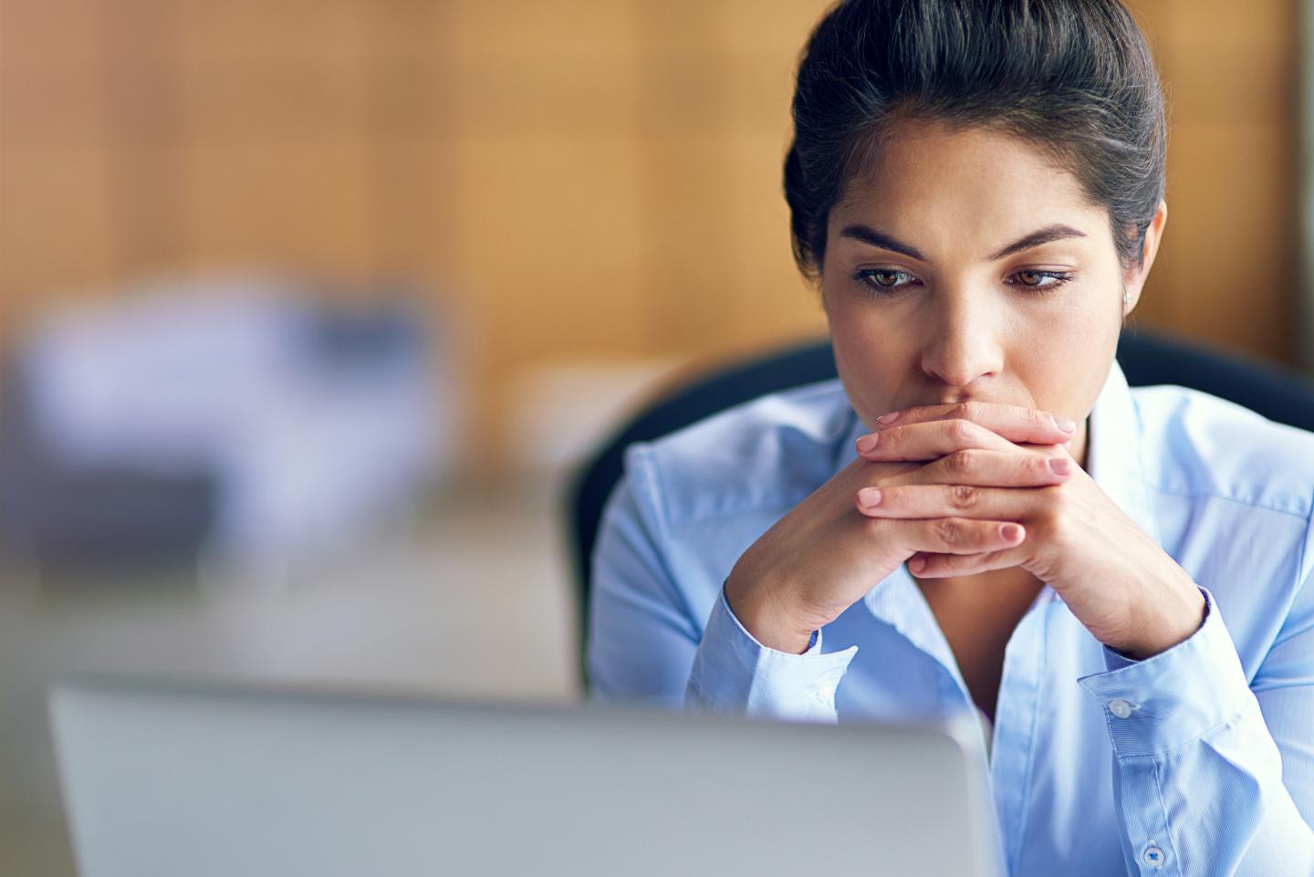 Shot of an executive looking stressed while working on her computer
