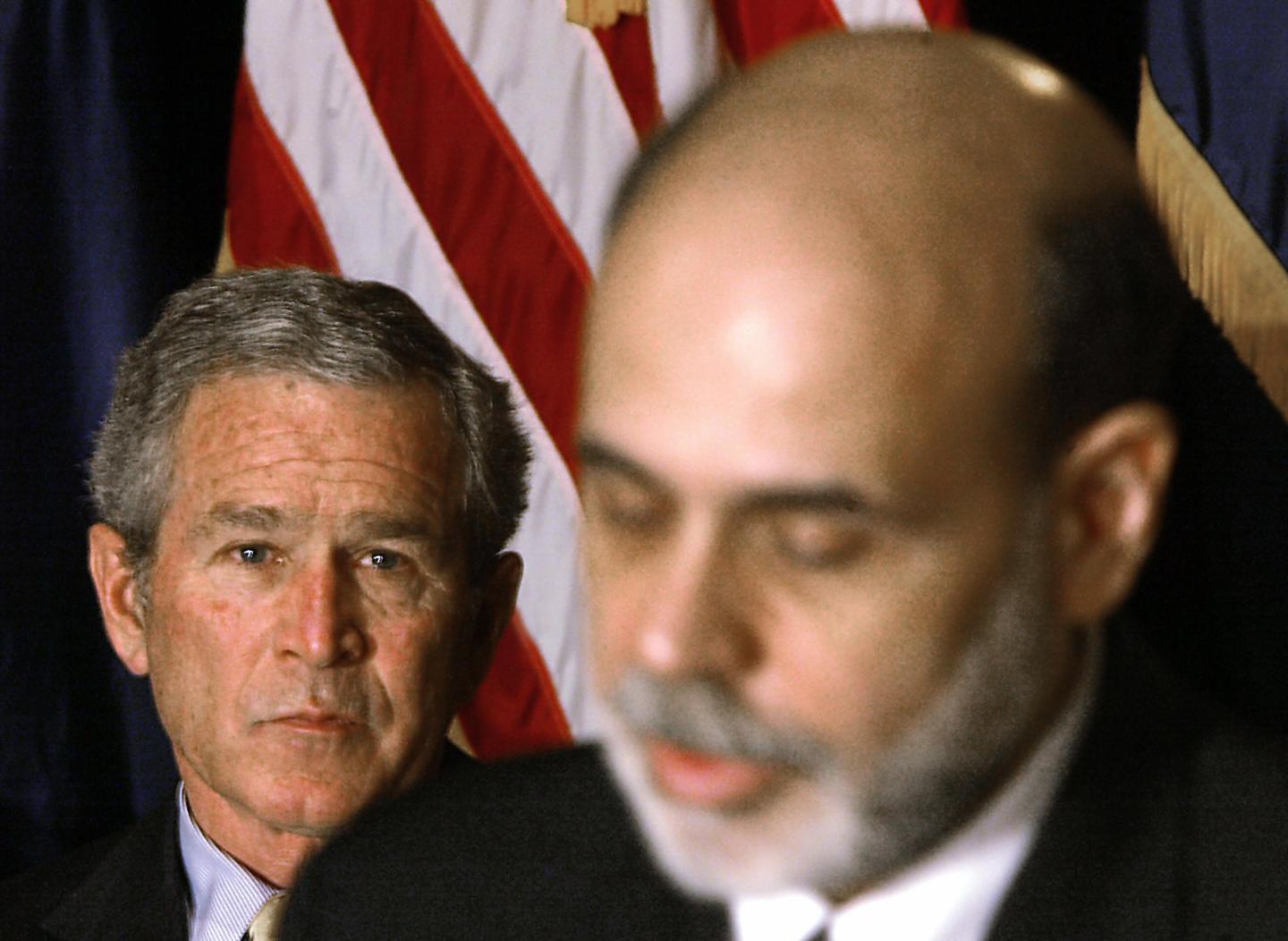 President George W. Bush (L) looks on as Ben Bernanke (R) speaks after he was sworn in as the 14th Federal Reserve Chairman at the Federal Reserve in Washington, DC, 06 February 2006.