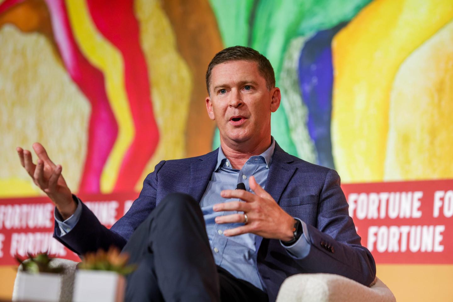 Dan Sheridan gestures while sitting in a chair at Fortune's COO summit.