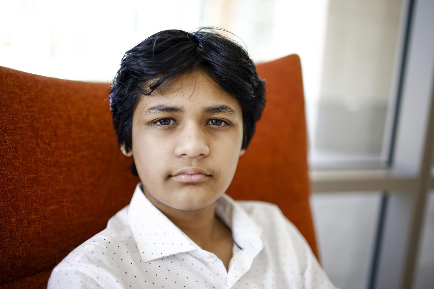 Kairan Quazi looks at the camera with a strong look in his yees.