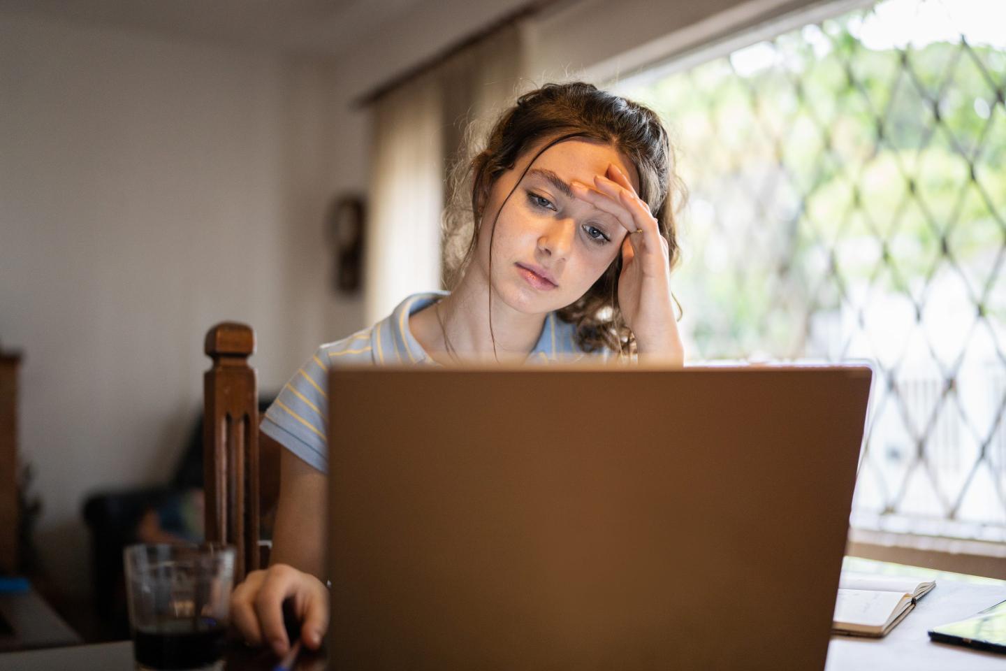 Sad job-seeking Gen Zer on laptop
