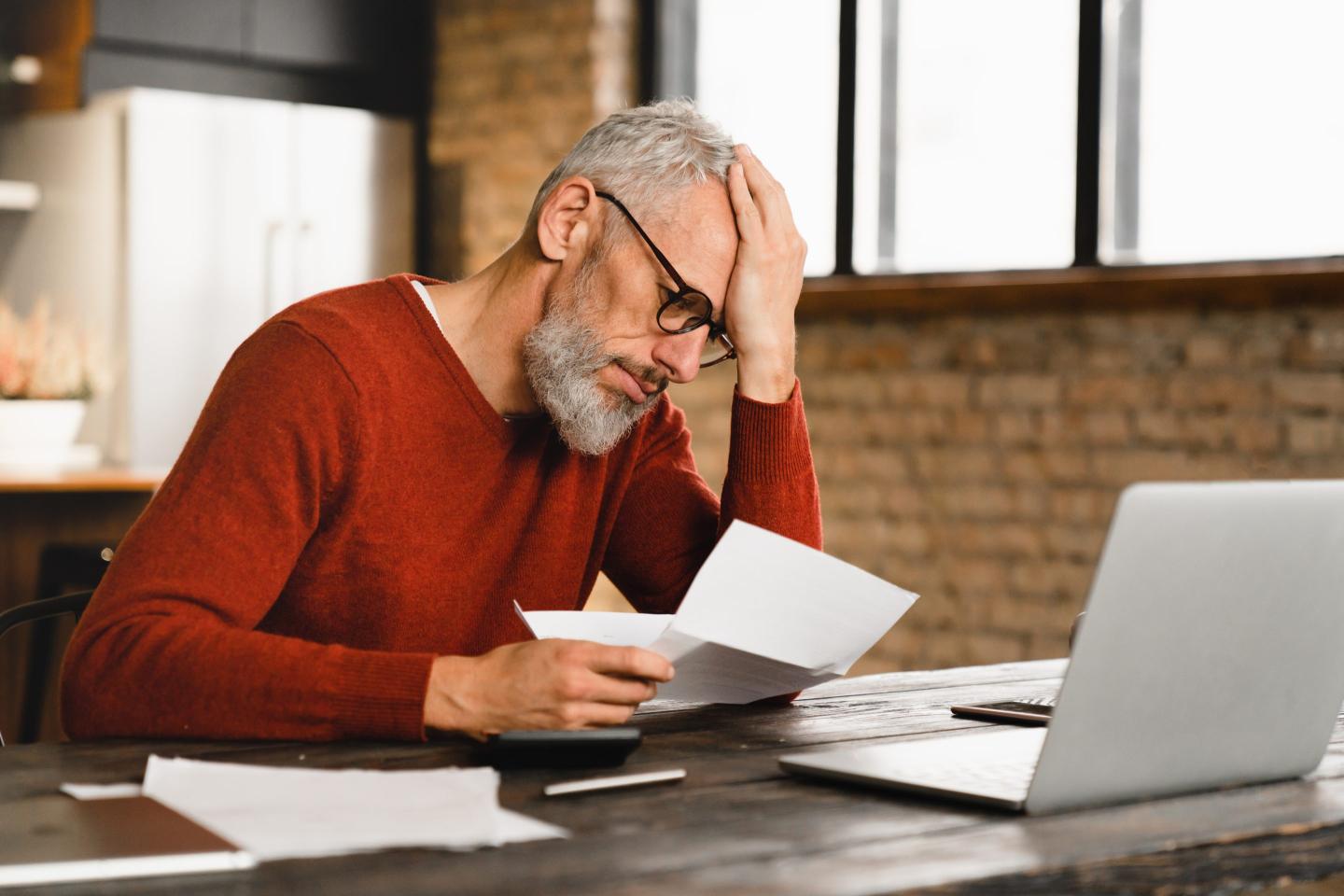 Rich stressed person looking at bills