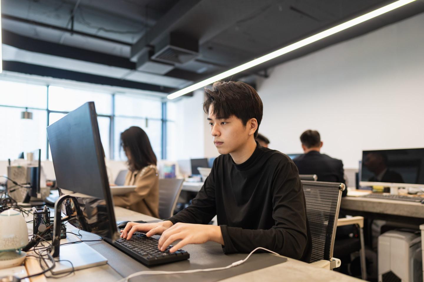 Young worker sits in office