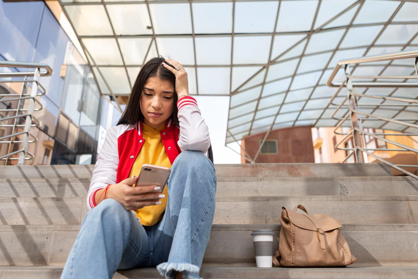 Girl reading phone upset