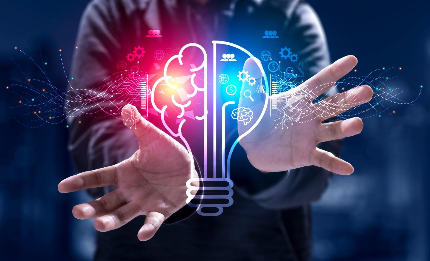 Stock photo of hands around a red and blue lightbulb