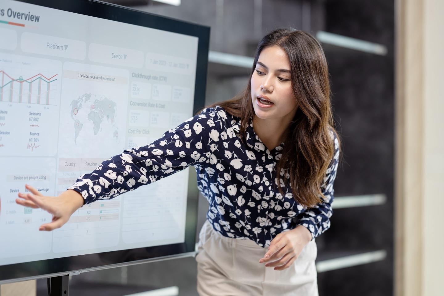 woman pointing out statistics on presentation