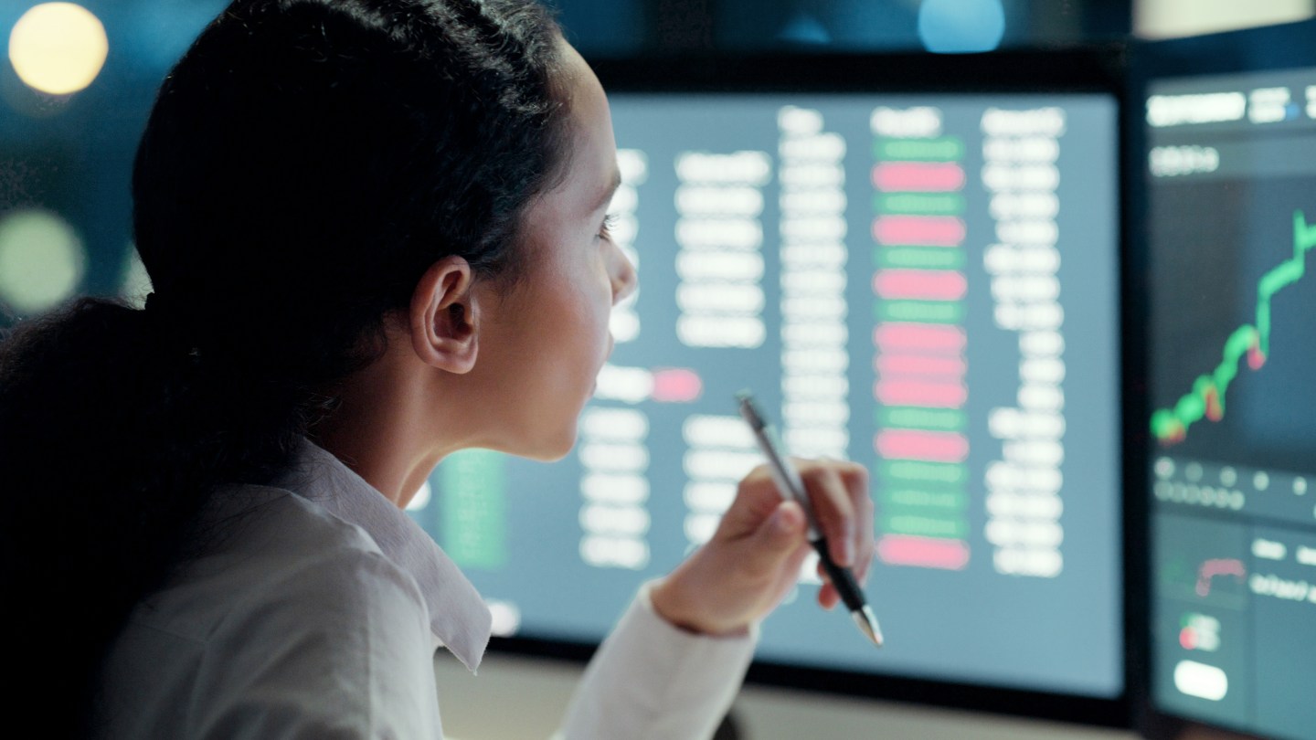 Business woman thinking and working on a computer