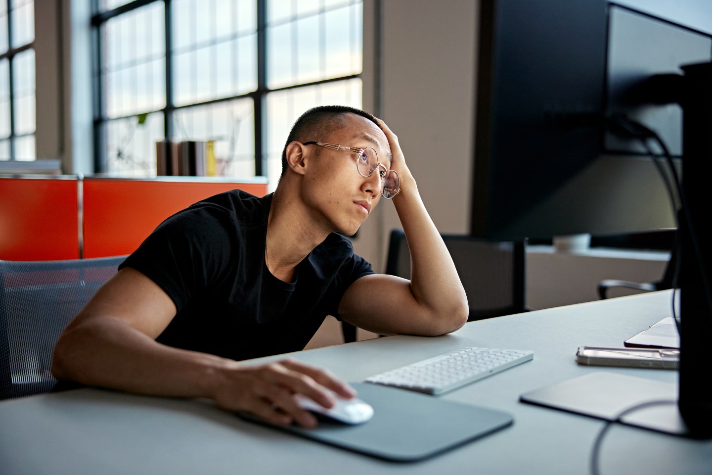 Office worker doing work on desktop computer.
