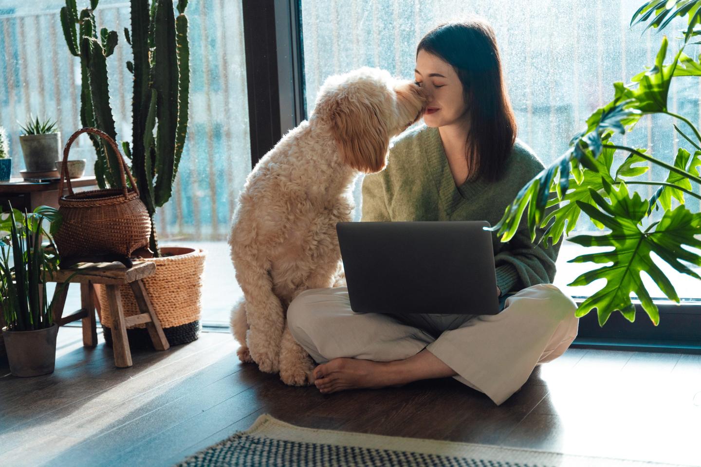 Woman working from home with her dog