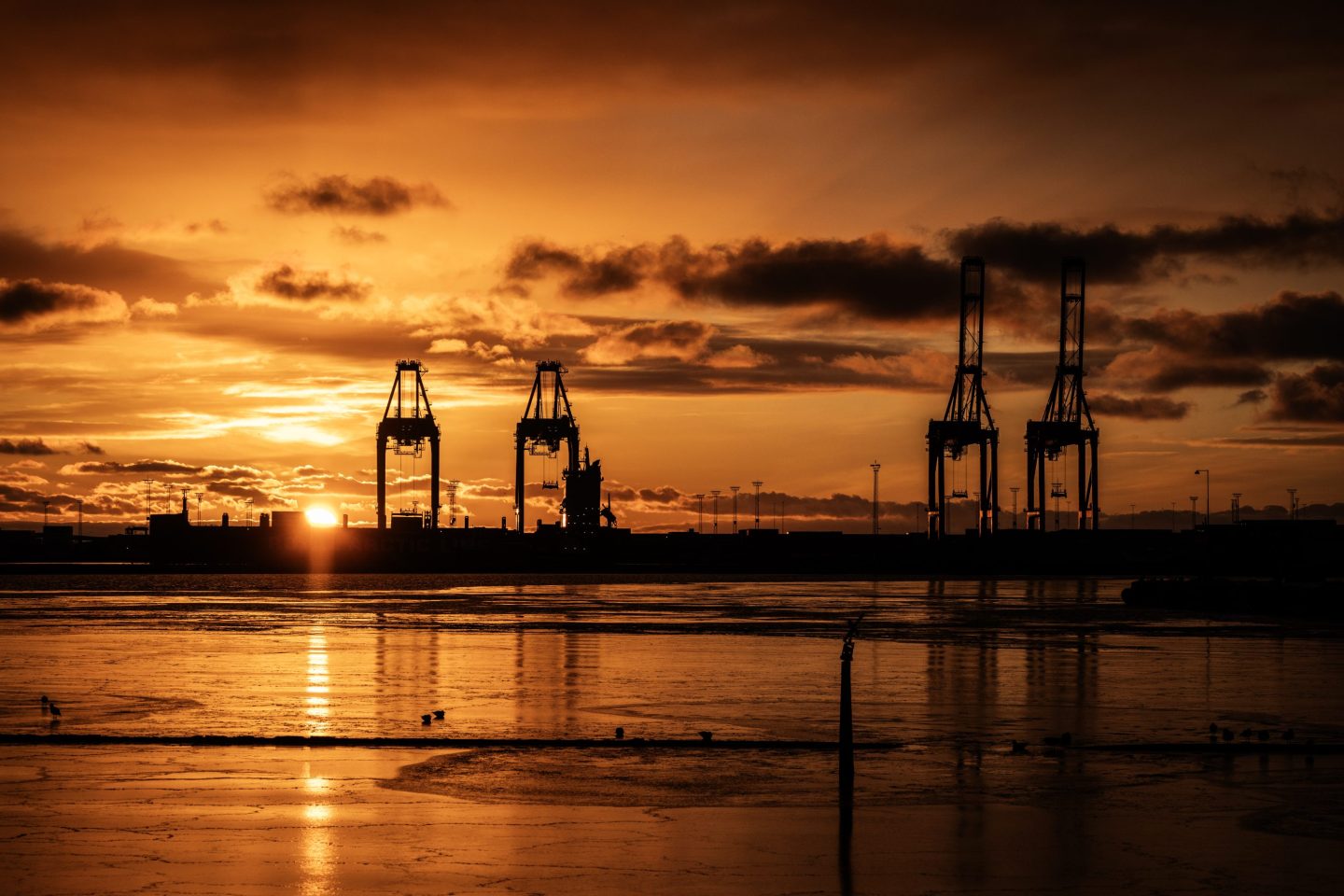 A sun sets over the port of Aarhus, a deep-sea port in Aarhus, Denmark.