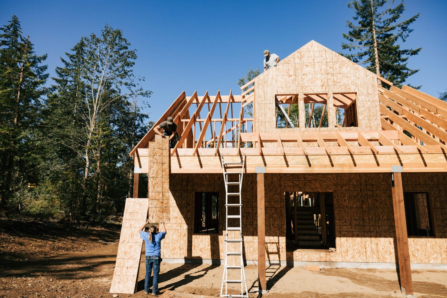 Workers build the frame of a new house in Washington State