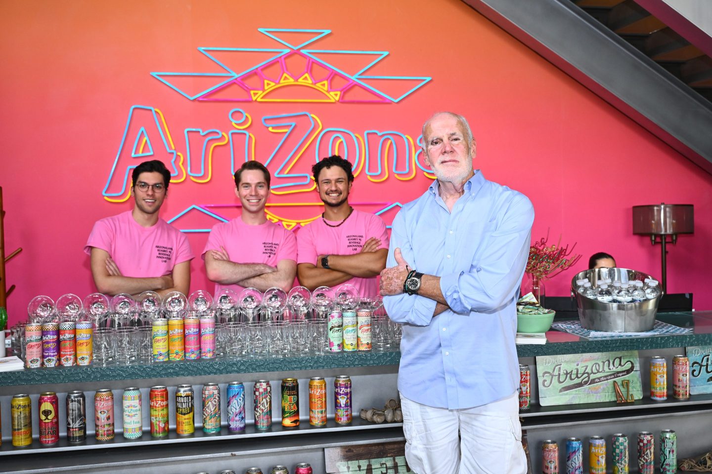 Don Vultaggio, cofounder of the AriZona Beverage Company, stands in front of a booth advertising his famous drinks