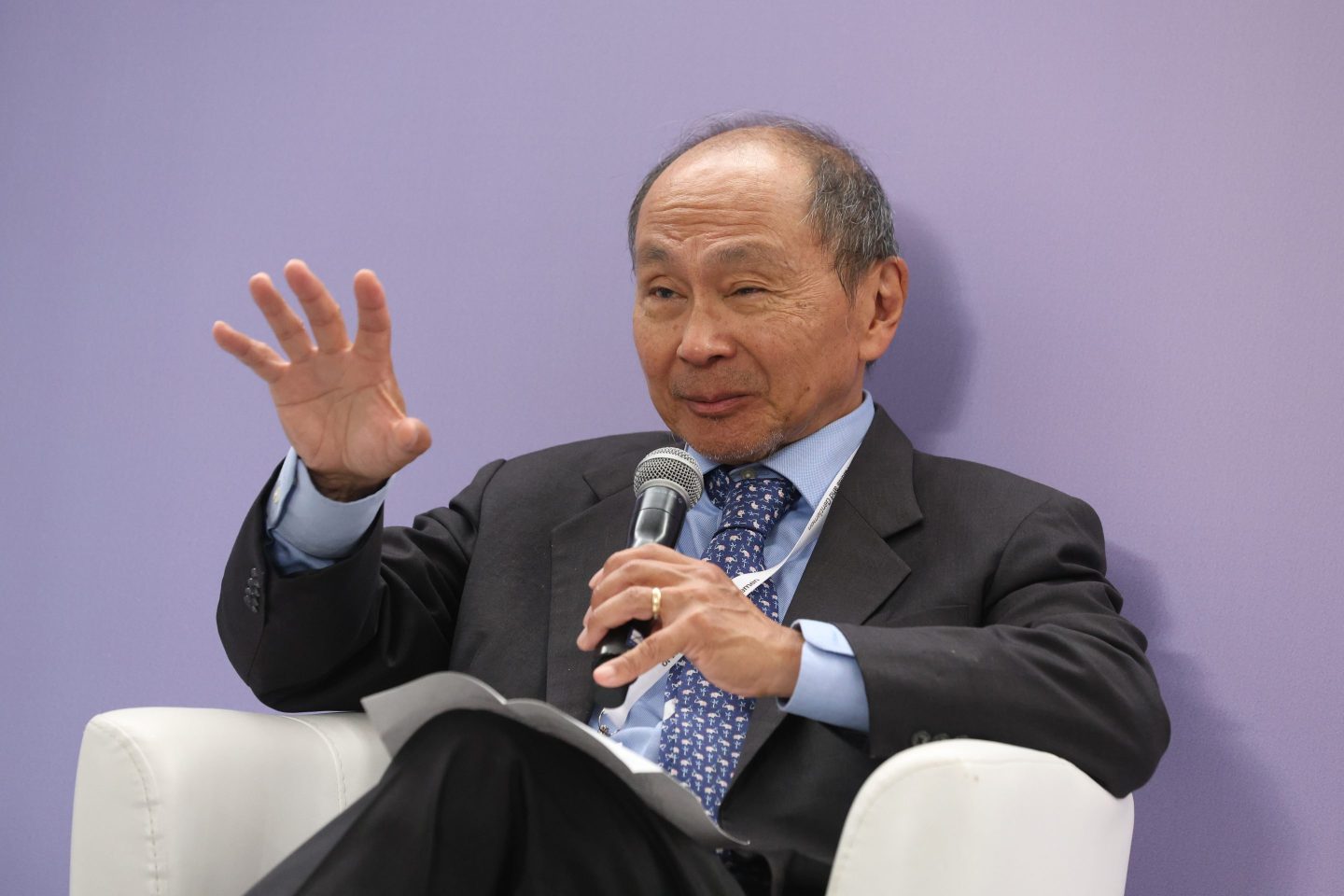 Francis Fukuyama speaks into a microphone