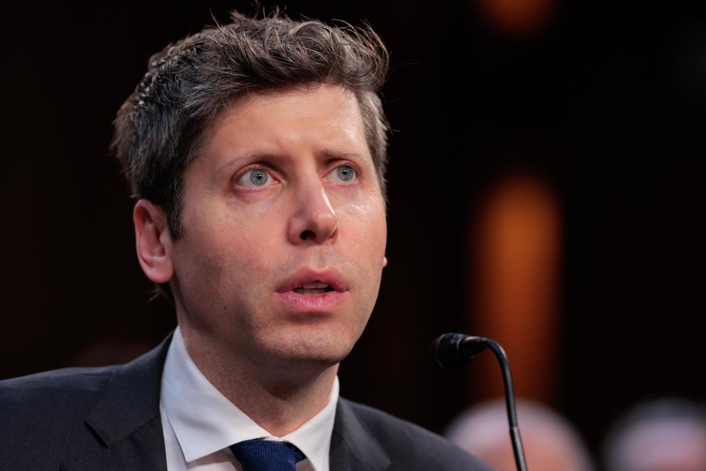 Sam Altman speaking into a mic.