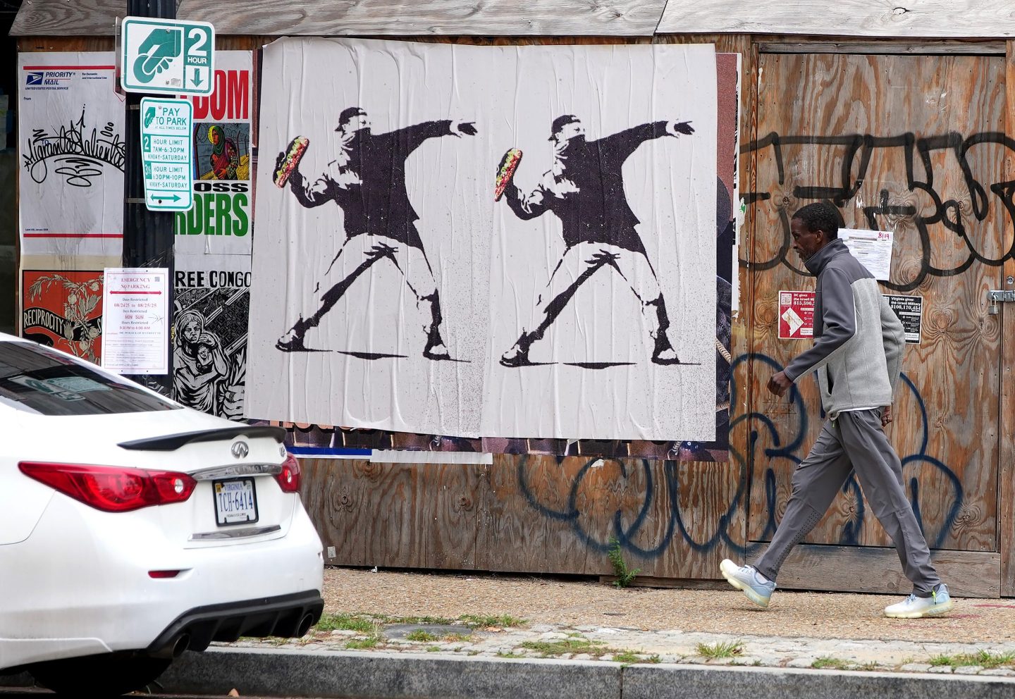 Banksy-style posters of a protester throwing a sandwich on August 21, 2025 in Washington, DC.