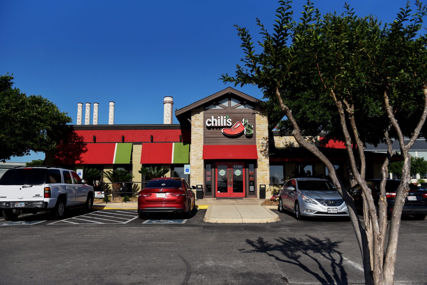 Vehicles sit parked outside a Brinker International Inc. Chili's