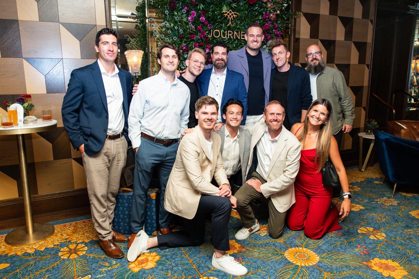 Several people posing for a photo at a Journey event.