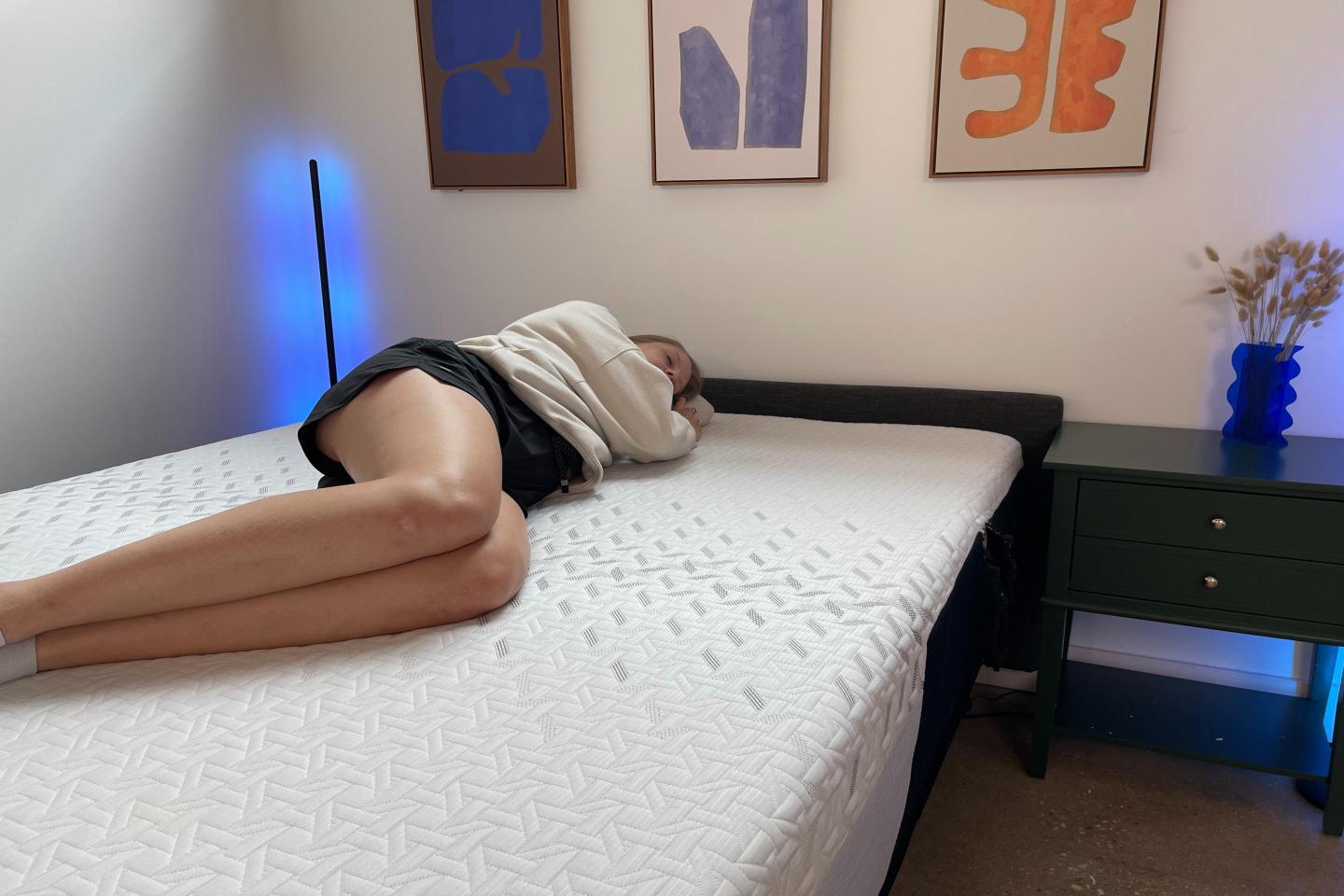 Tester laying on mattress