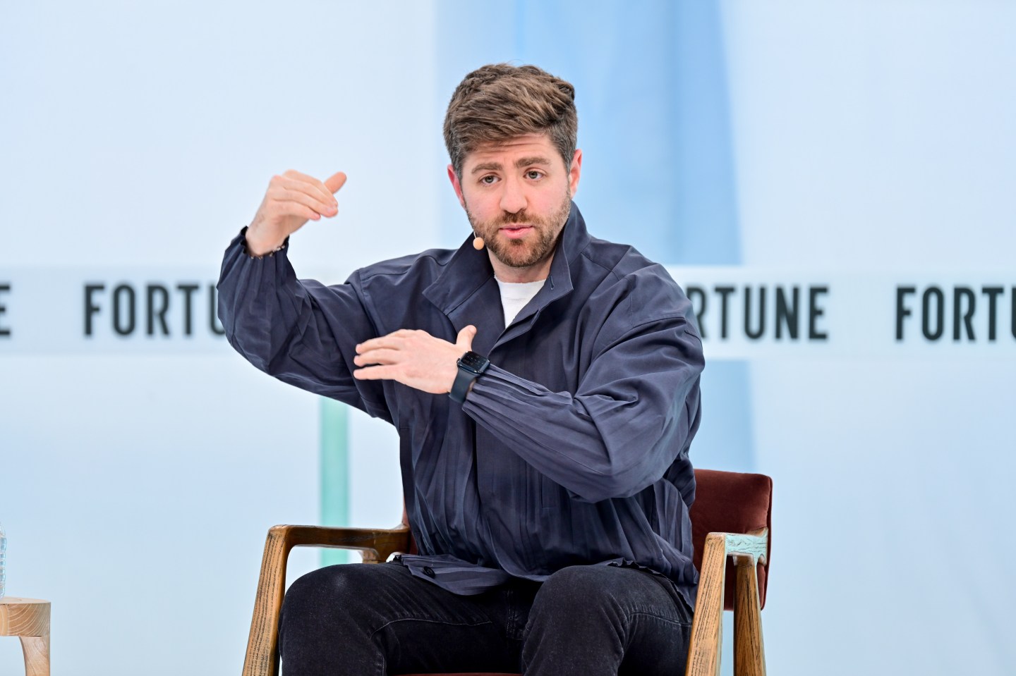 Ramp CEO Eric Glyman gesticulating onstage at Fortune Brainstorm Tech 2025
