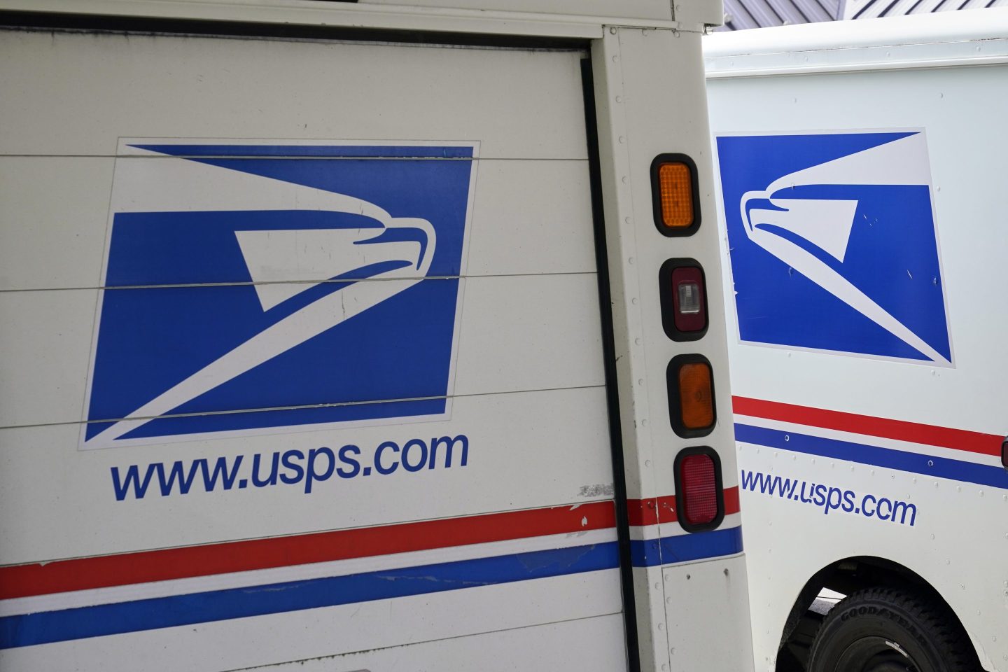 U.S. Postal Service delivery vehicles are parked outside a post office in Boys Town, Neb.