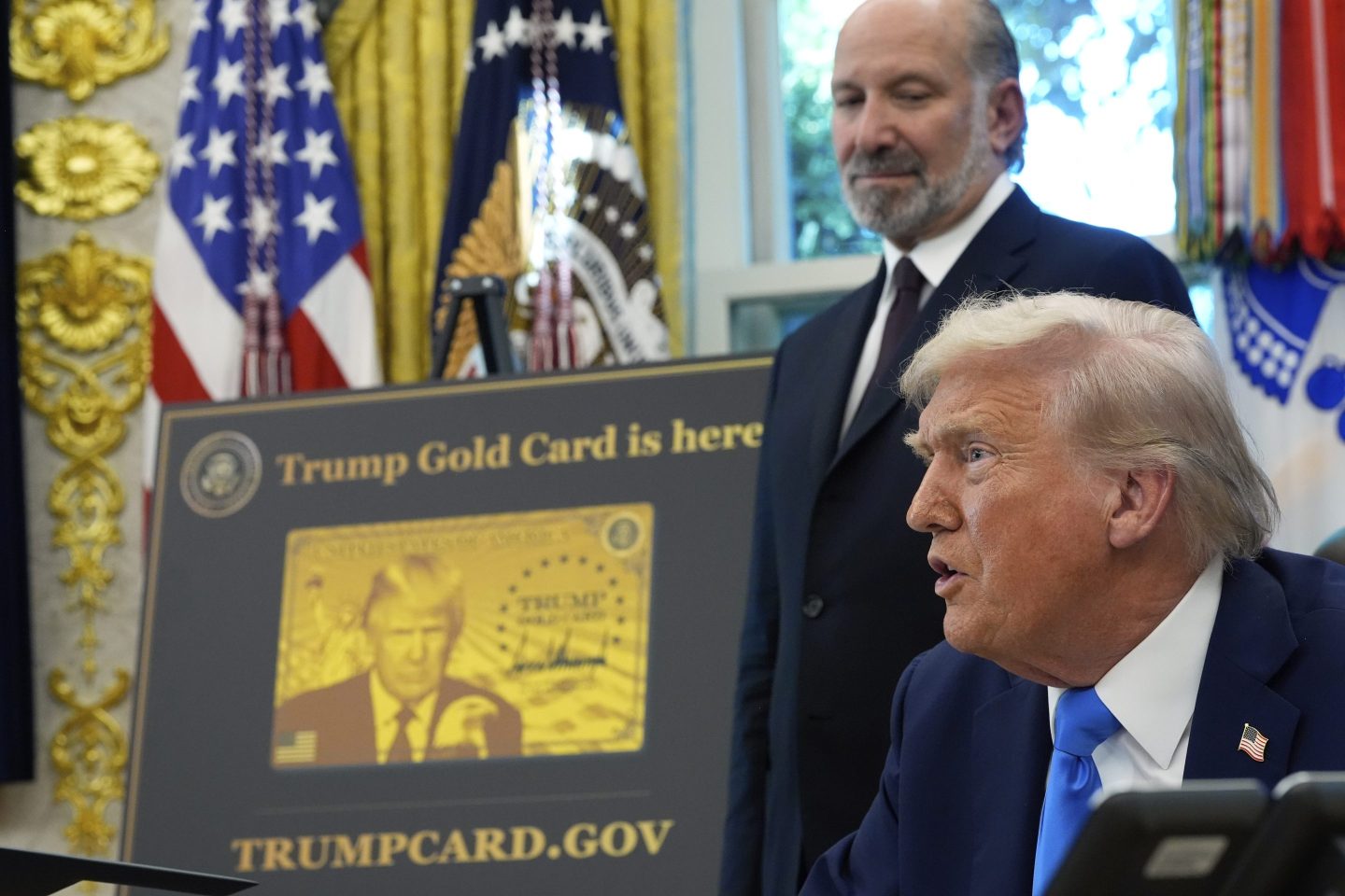 President Donald Trump speaks as Commerce Secretary Howard Lutnick listens in the Oval Office of the White House on Friday.