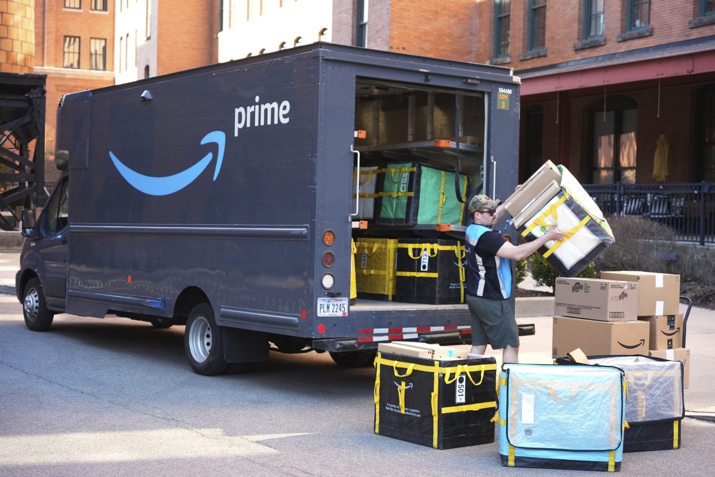 An Amazon Prime driver makes a delivery outside an apartment building in Pittsburgh, March 10, 2025.