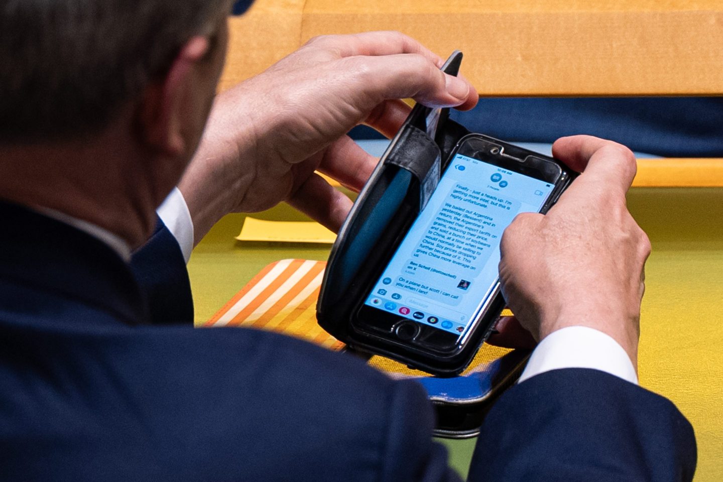 A man looks at a text on his phone