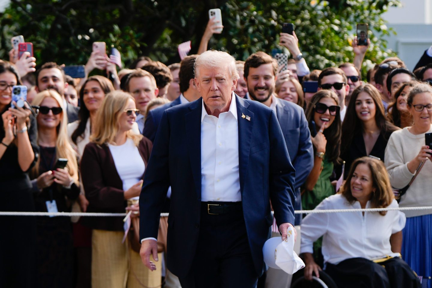 President Donald Trump walks to speak with reporters after greeting supporters before departing the White House, Friday, Sept. 26, 2025, in Washington.