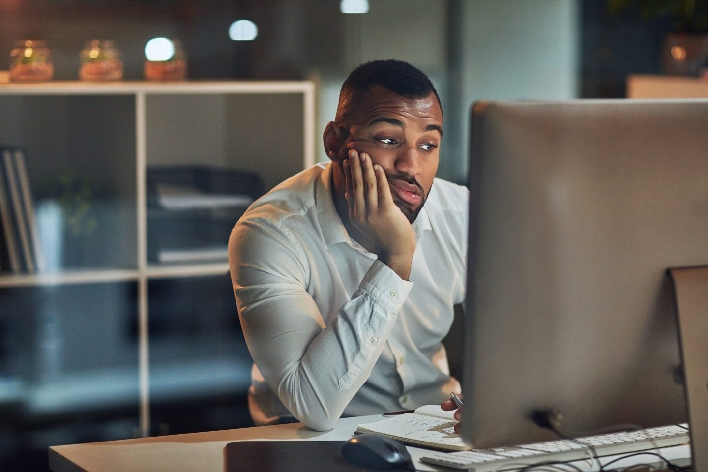 Annoyed worker at desk.