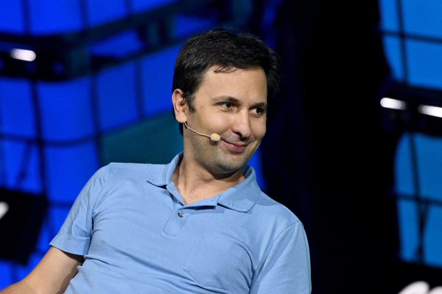 Young man in a blue shirt with a microphone