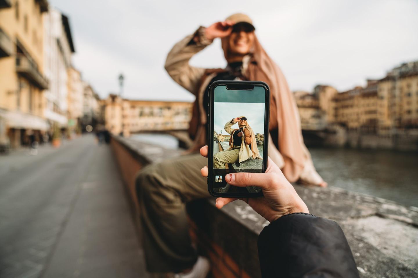 Young adult woman taking a picture with friend