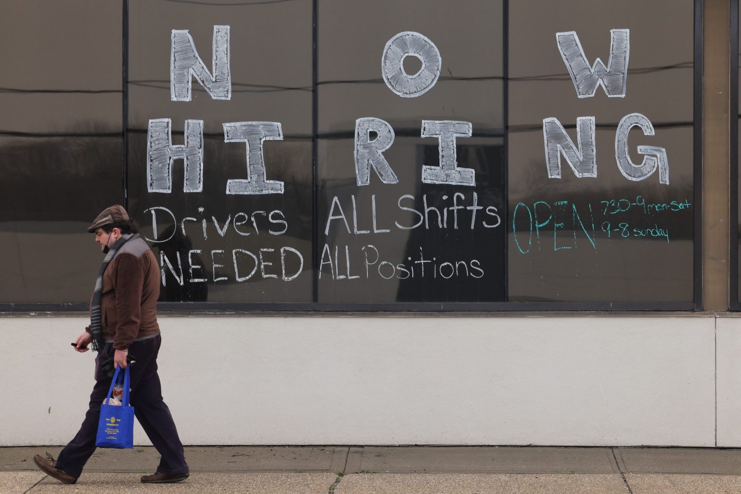 A large "Now Hiring" advertisement posted on the windows of the Advance Auto Parts store in Bay Shore, New York on March 24, 2022.