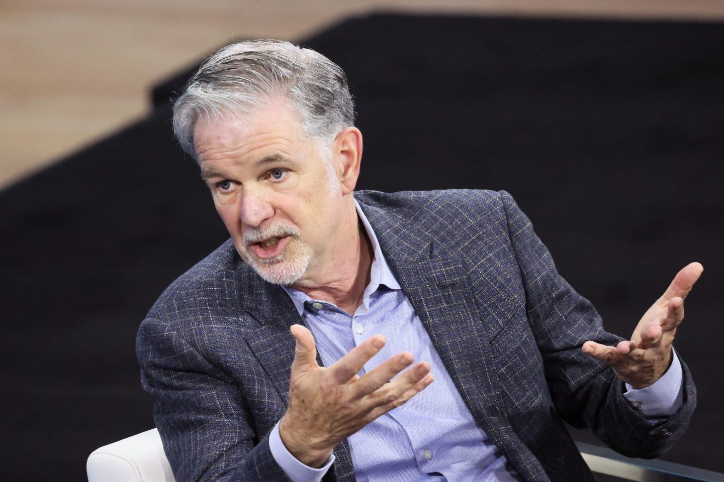 Netflix founder and Co-CEO Reed Hastings speaks with his hands raided during the New York Times DealBook Summit in the Appel Room at the Jazz At Lincoln Center on November 30, 2022 in New York City.