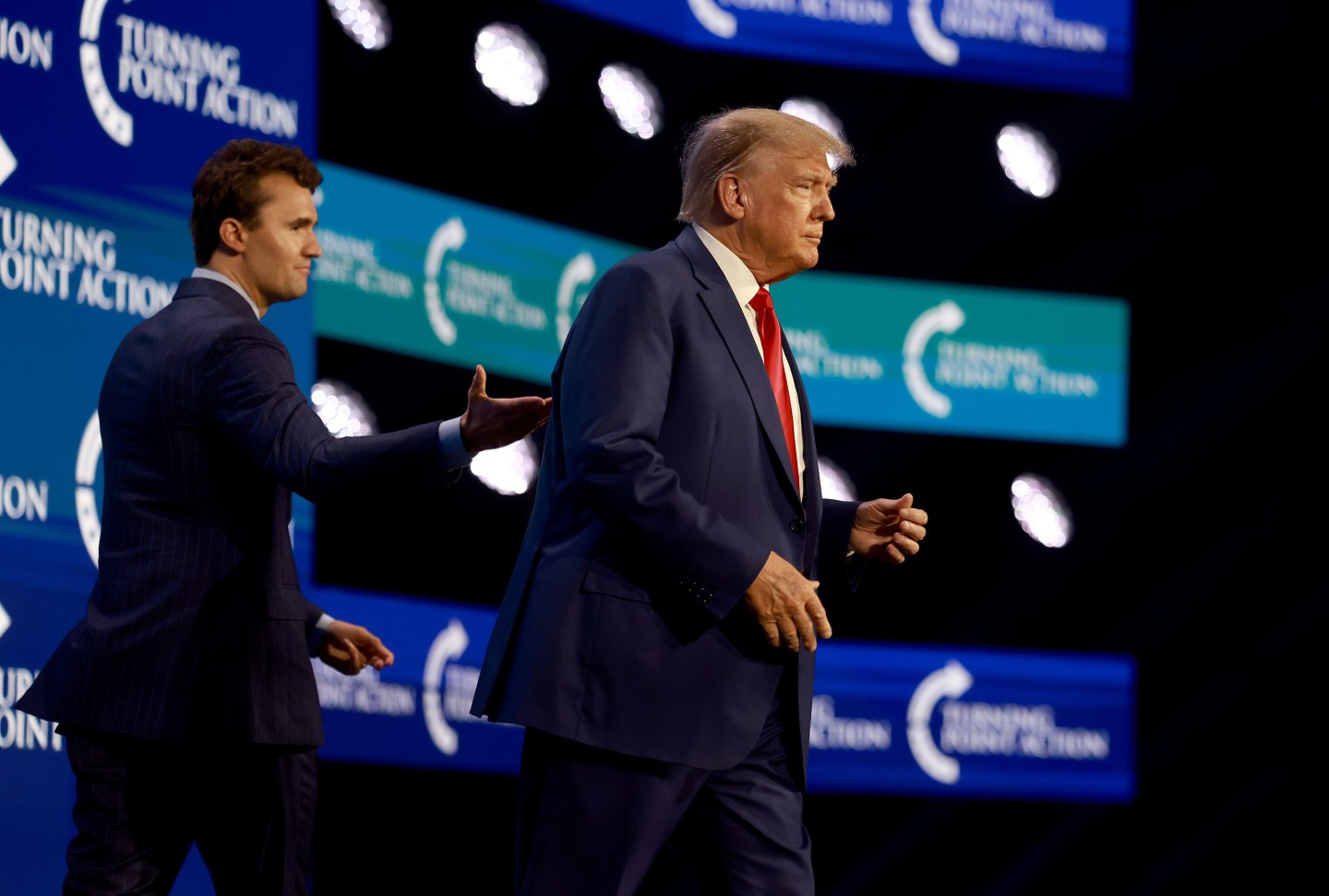 Charlie Kirk walks with Donald Trump