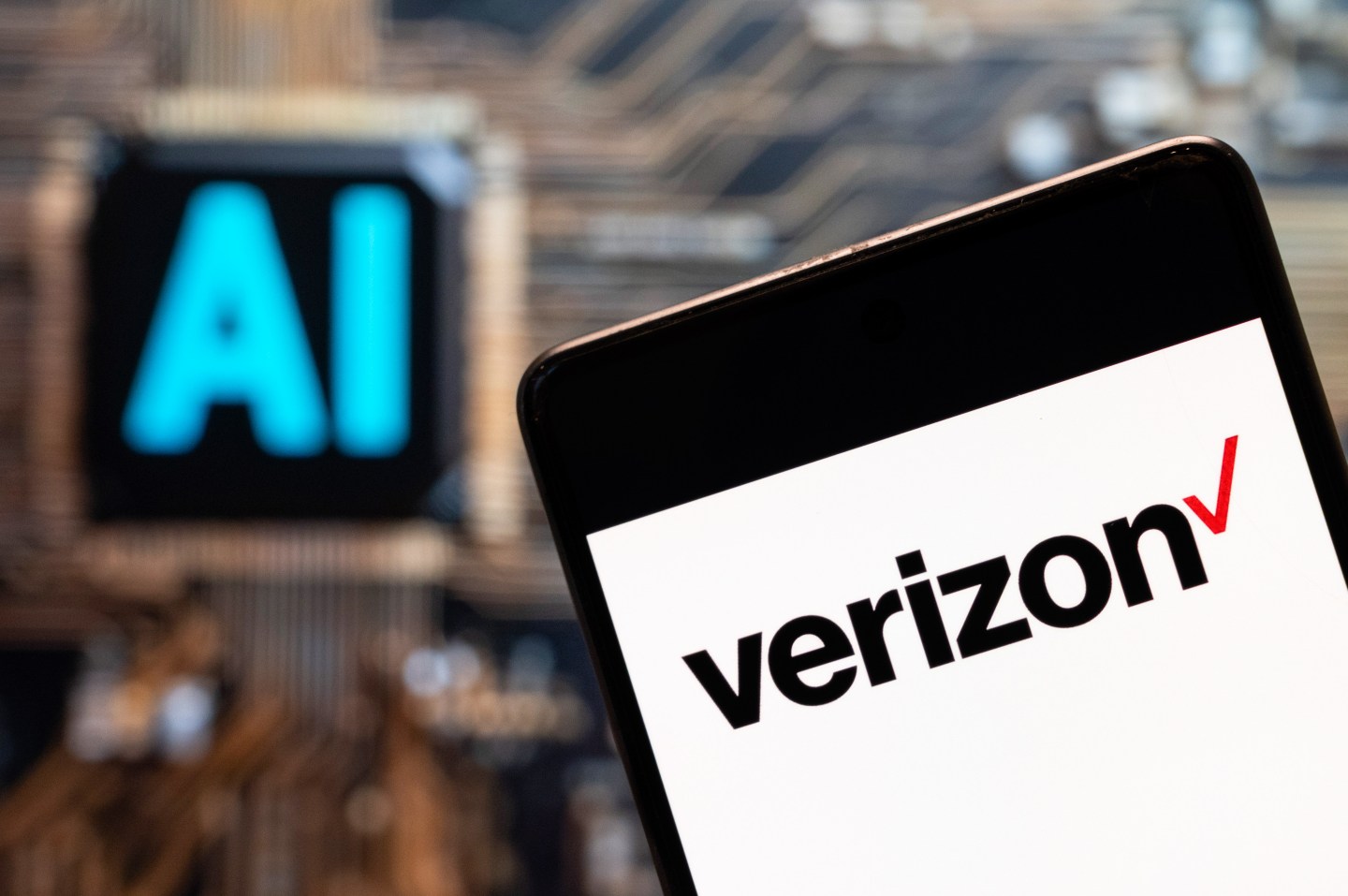 The American multinational telecommunications conglomerate Verizon logo seen displayed on a smartphone with an artificial intelligence chip and symbol in the background.