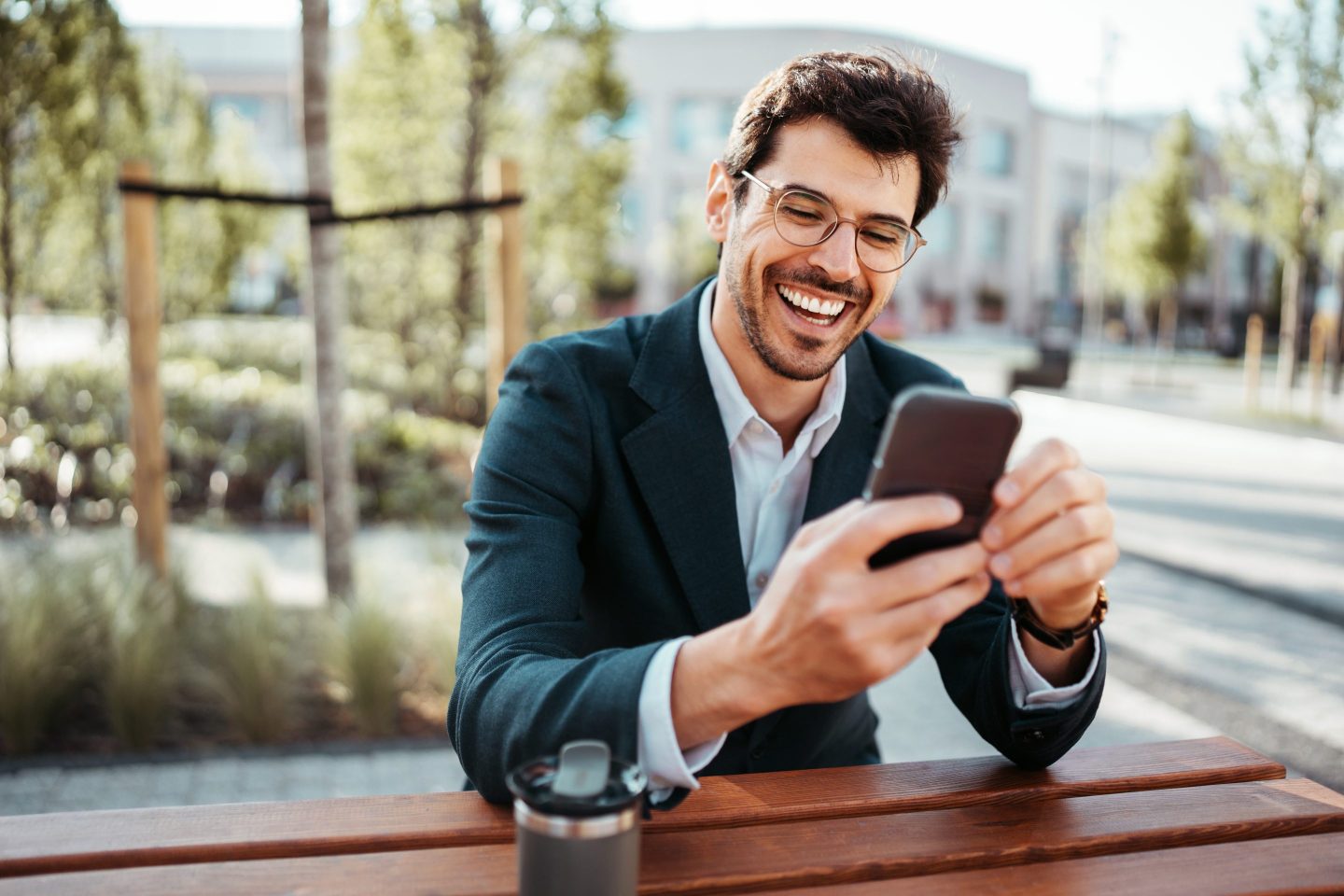 Businessman using a phone in a city