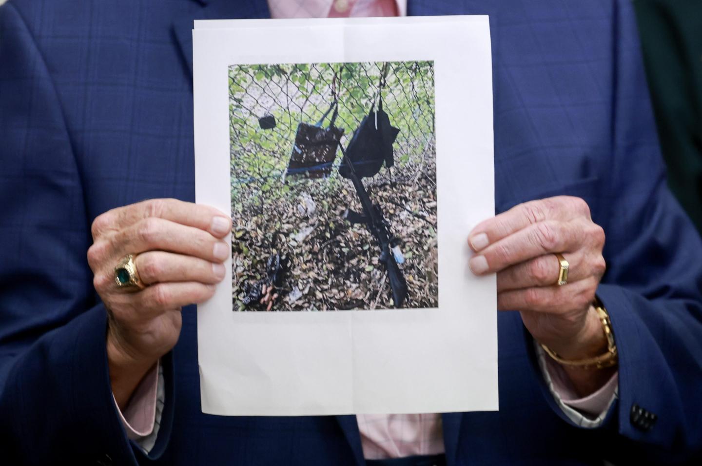 Palm Beach County Sheriff Ric Bradshaw holds a photograph of the rifle and other items found near where a suspect was discovered during a press conference regarding an apparent assassination attempt of former President Donald Trump on September 15, 2024 in West Palm Beach, Florida.