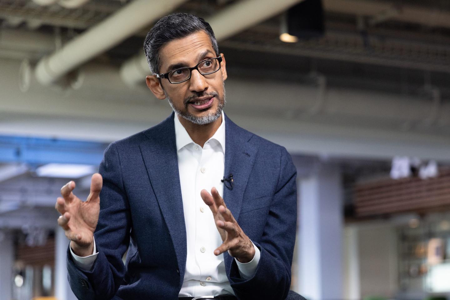 Photo of Alphabet CEO Sundar Pichai with his hands out.