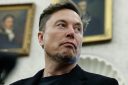 Elon Musk listens as reporters ask U.S. President Donald Trump and South Africa President Cyril Ramaphosa questions during a press availability in the Oval Office at the White House on May 21, 2025 in Washington, DC.