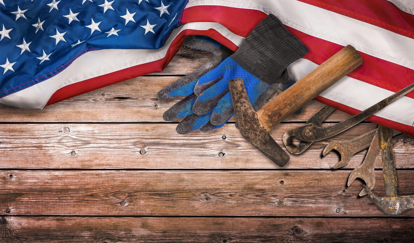 Work tools on a workbench with an American flag for some reason