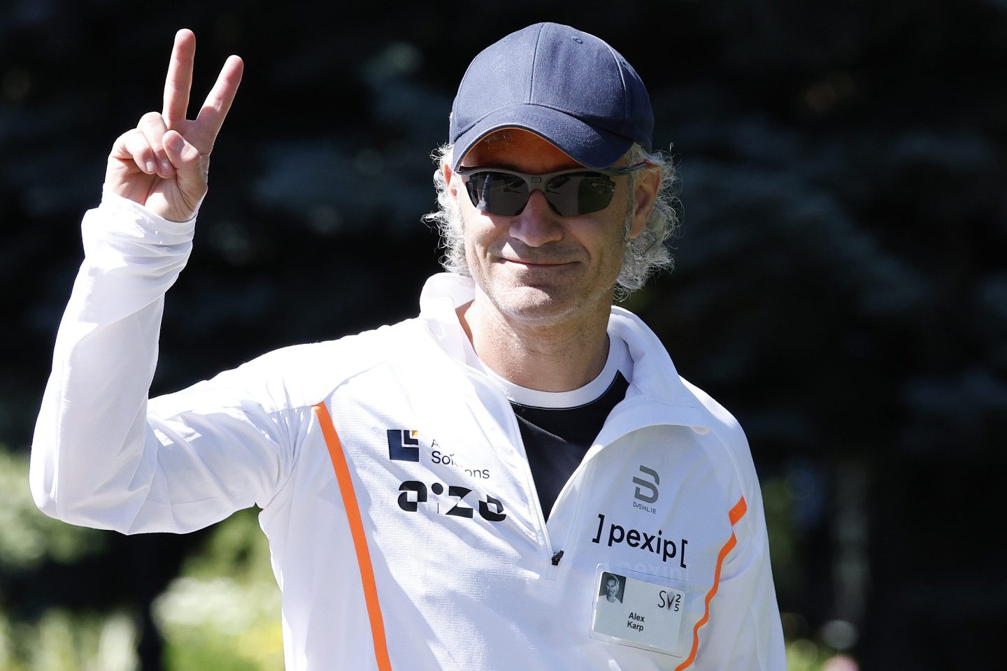 Alex Karp gives a peace sign