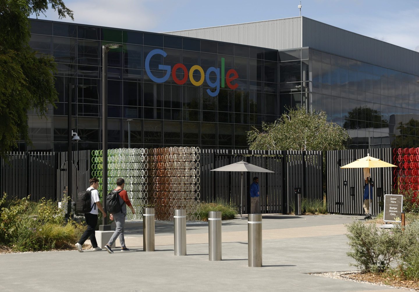 MOUNTAIN VIEW, CALIFORNIA - JULY 23: Workers enter a building on the Google headquarters campus on July 23, 2025 in Mountain View, California. Google parent company Alphabet reported better-than-expected second-quarter earnings with revenue of $96.43 billion compared to analyst expectations of $94 billion. (Photo by Justin Sullivan/Getty Images)