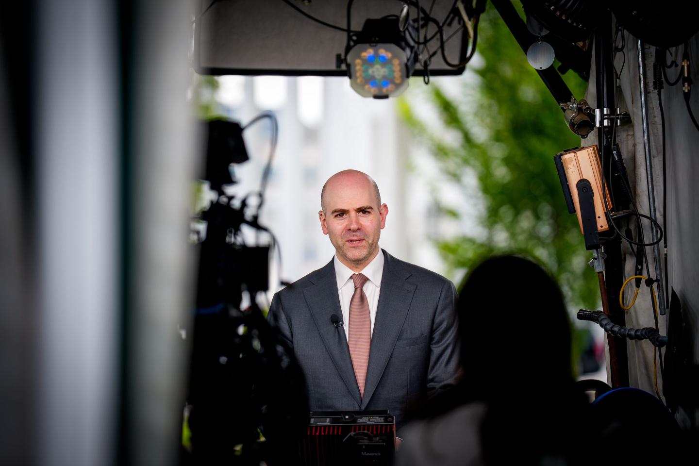 President Donald Trump's pick to fill a Fed vacancy, Stephen Miran, is surrounded by cameras as he does an interview in front of the white house.